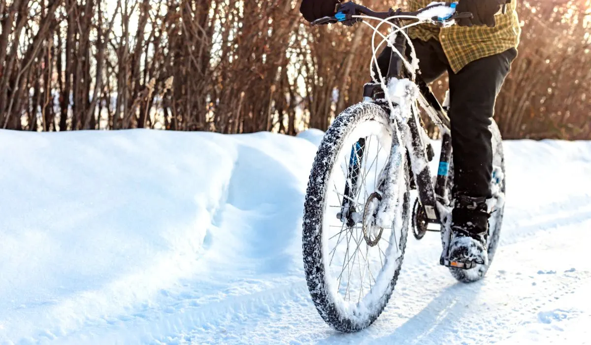 A person riding a bike through the snow.