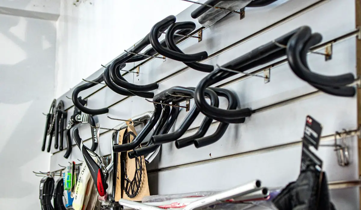 Bike handle bars for sale hanging up in a bike shop.