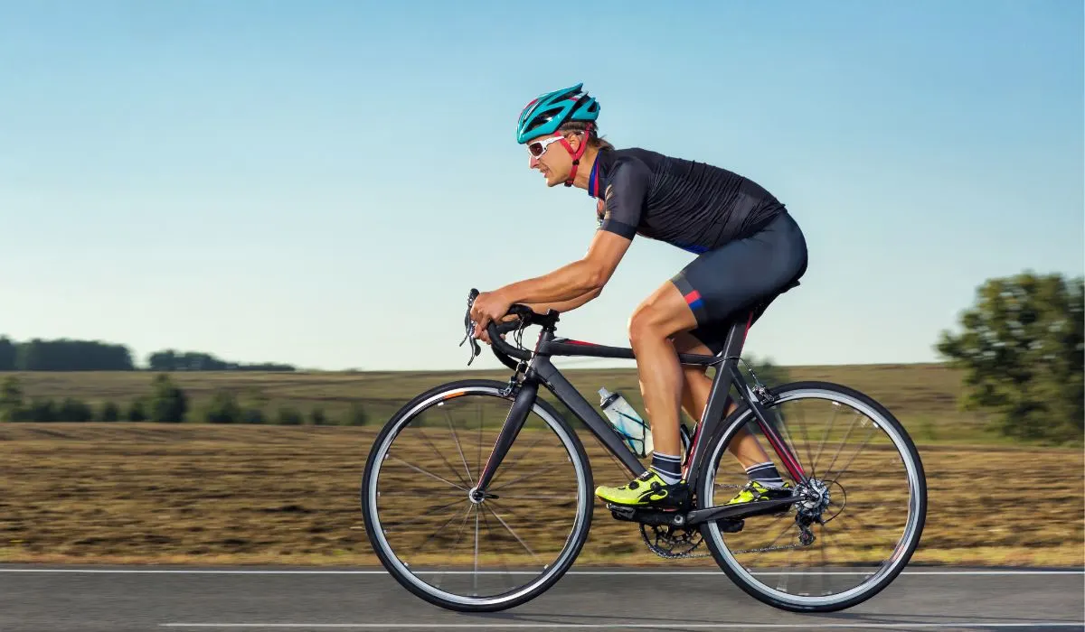 A side view of a cyclist on a road bike with good posture. 