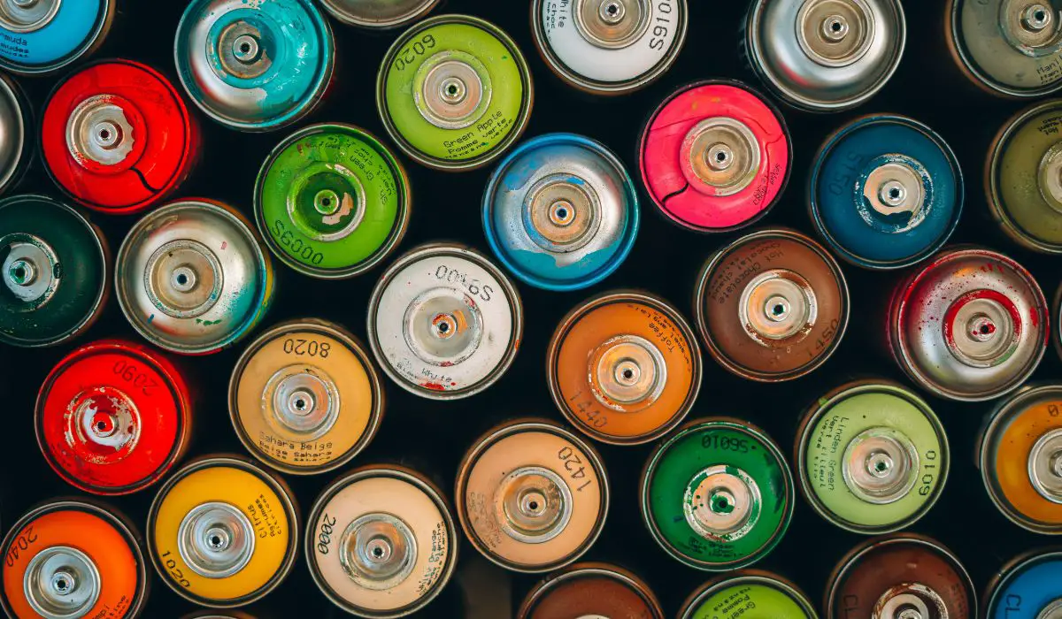 Cans of spray paint in various colors. 