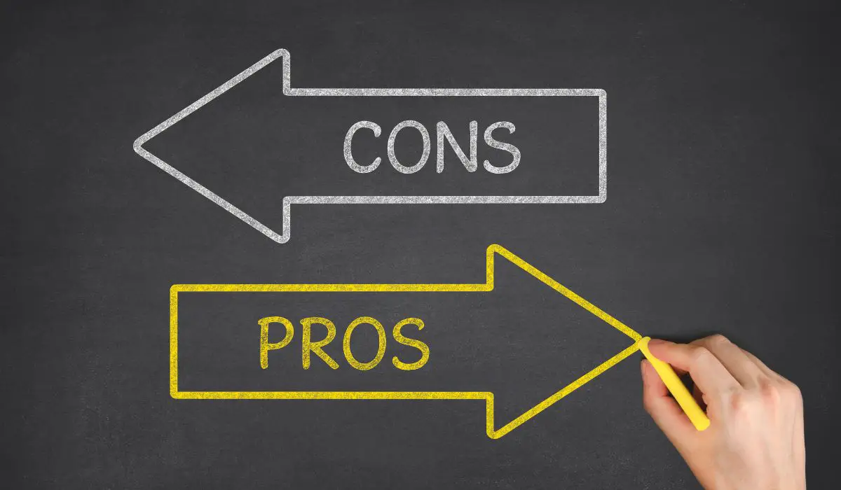 A hand writing arrows pointing in different directions stating pros and cons. 