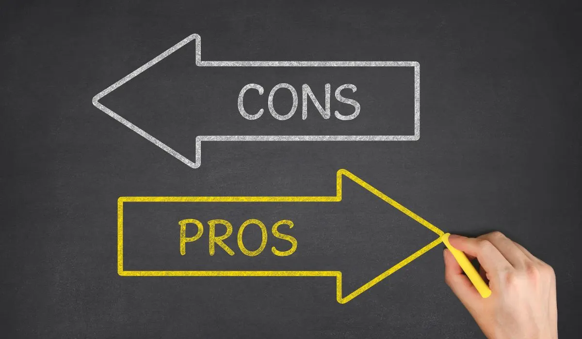 A hand writing arrows pointing in different directions stating pros and cons.