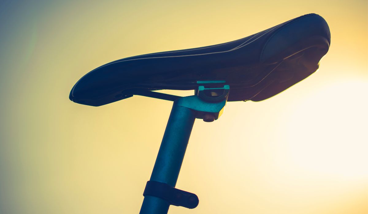 A lighted background with a road bike seat in the foreground.