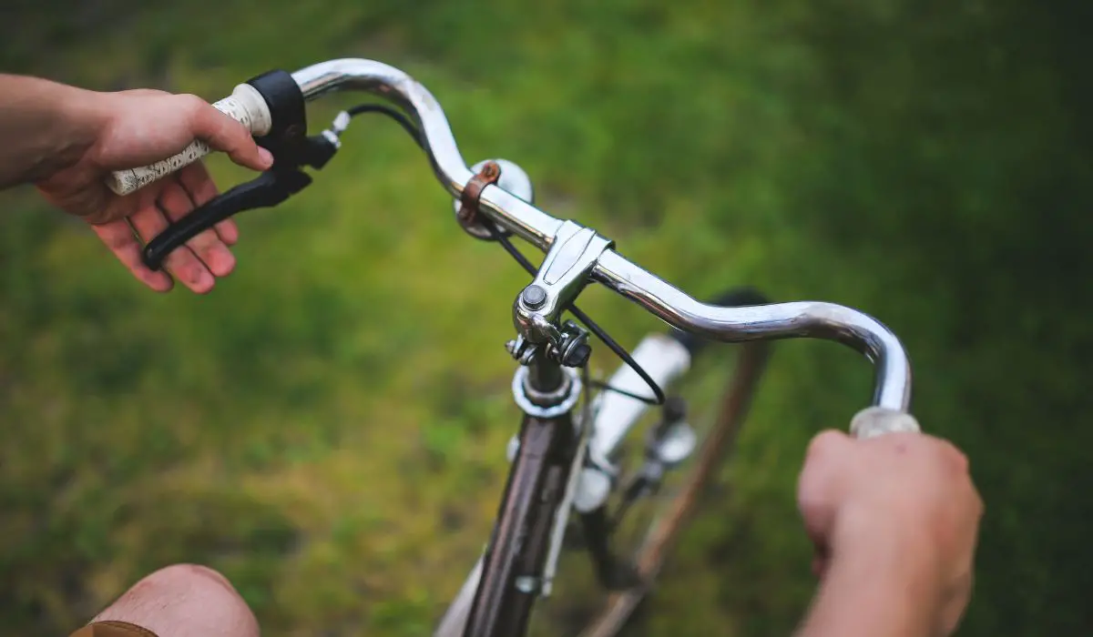 Bike handle bars that are bend back so the person holding them has bend wrists. 