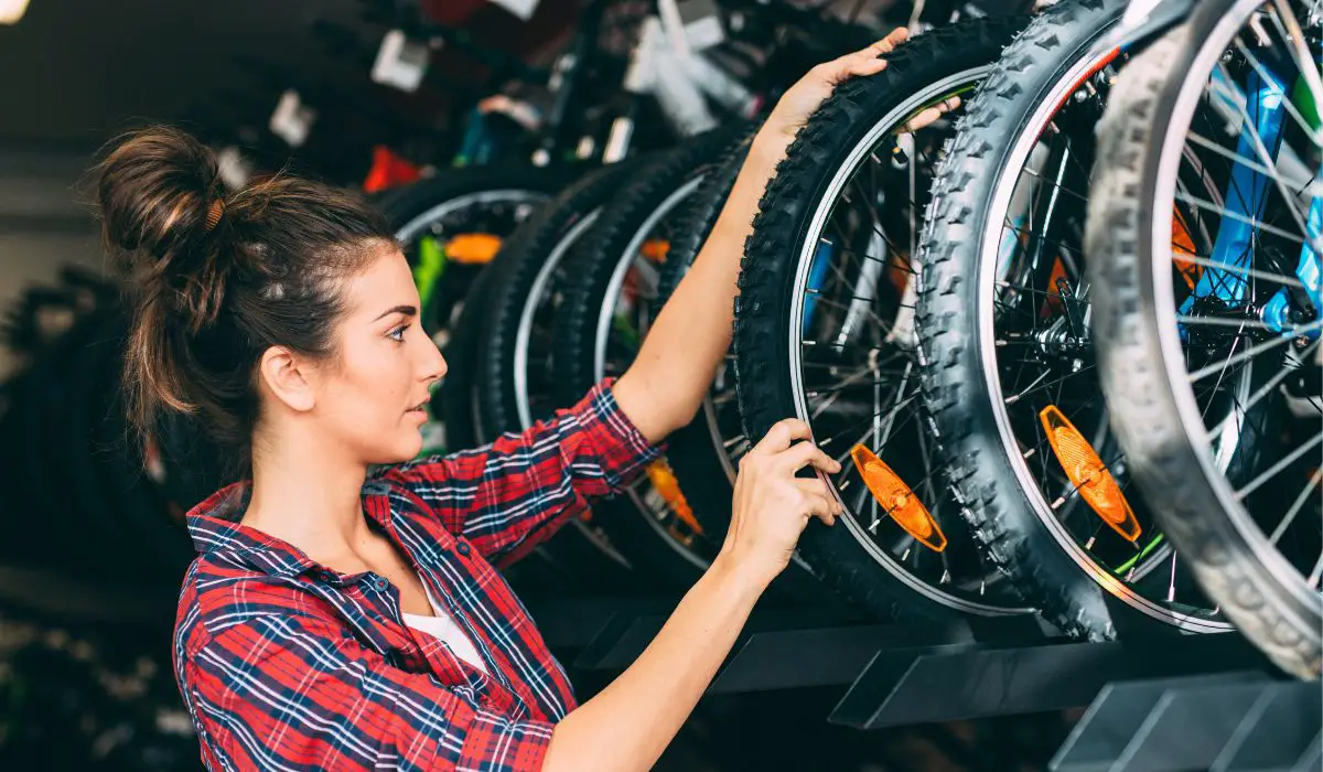 A woman looking at bikes in a bike store. 