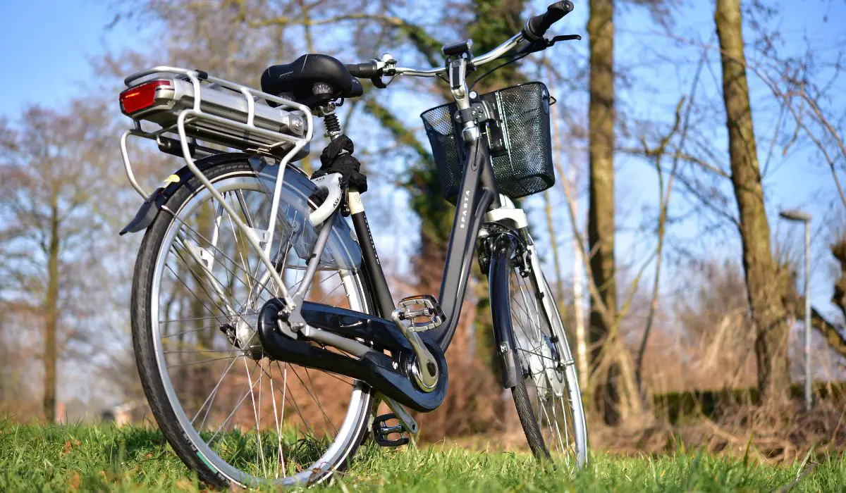 A bike with a back rack and a front basket, back view.