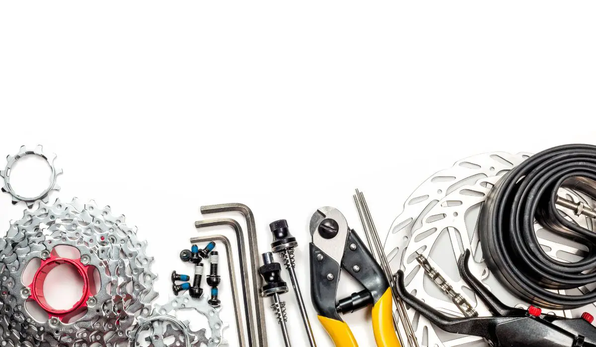 A white background with bike tools laid next to each other in a row.