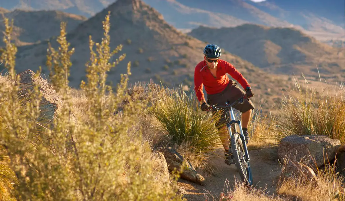 A man riding a mountain bike on difficult terrain. 